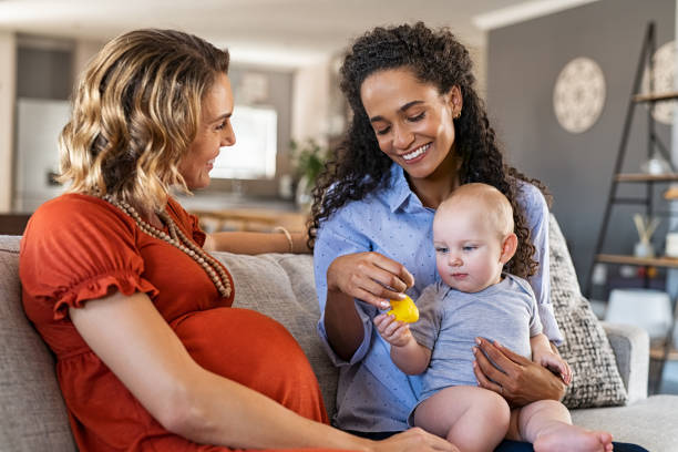 istock Happy women friends playing with child 1219120148