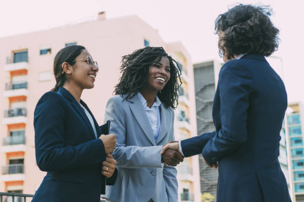 istock Multiethnic partners greeting each other near office 1219121201