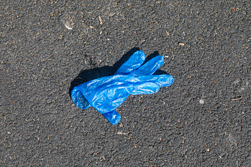 Covid-19 hygiene discarded gloves on the street
