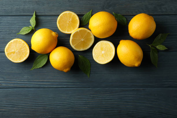 istock Fresh lemons on wooden background, top view. Ripe fruit 1219122506