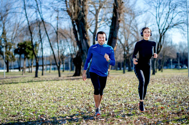 istock Young couple jogging together 1219122784
