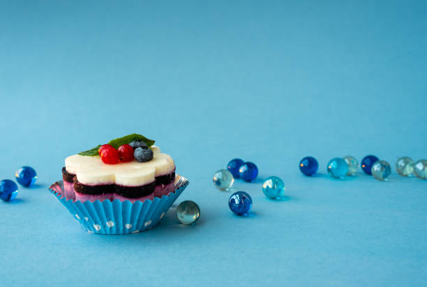 istock Tasty cake with berries on a blue background. 1219122929
