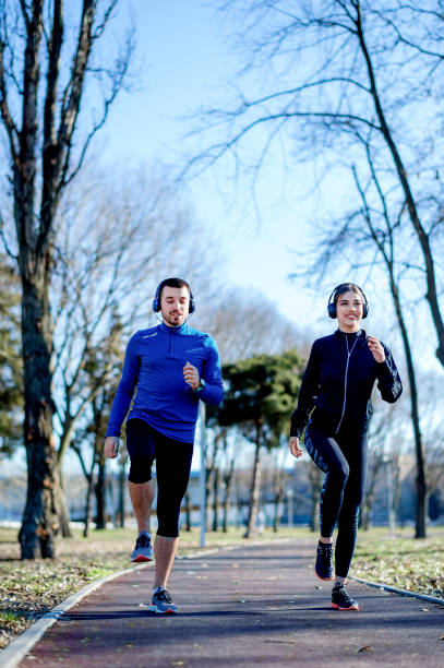 istock Young couple jogging together 1219123659
