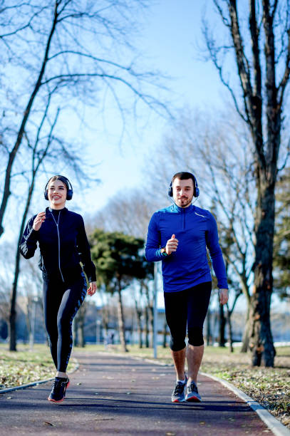 istock Young couple jogging together 1219123690