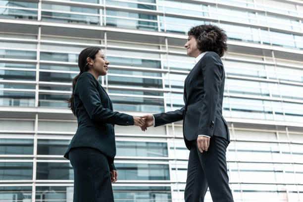 istock Friendly business partners greeting each other near office 1219123892