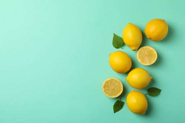 istock Fresh lemons on mint background, top view. Ripe fruit 1219124249