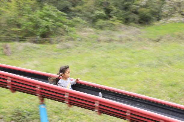 istock Japanese girl on the slide (5 years old) 1219125590