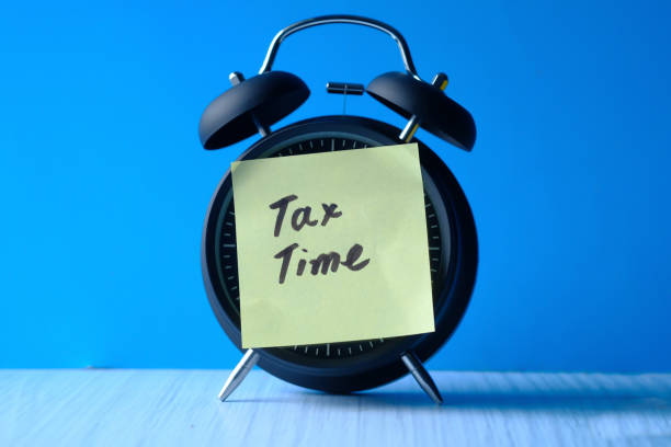 istock pay tax concept with clock and tax word 1219127044