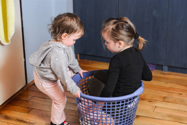istock Children playing whit laundry basket 1219128504