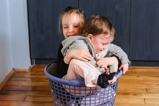 istock Children sitting in laundry basket 1219130026