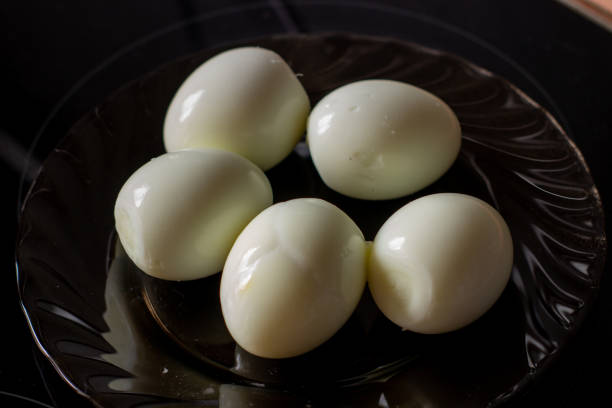 istock Peeled eggs on a black plate. Hard-boiled eggs. Cooking. 1219131491