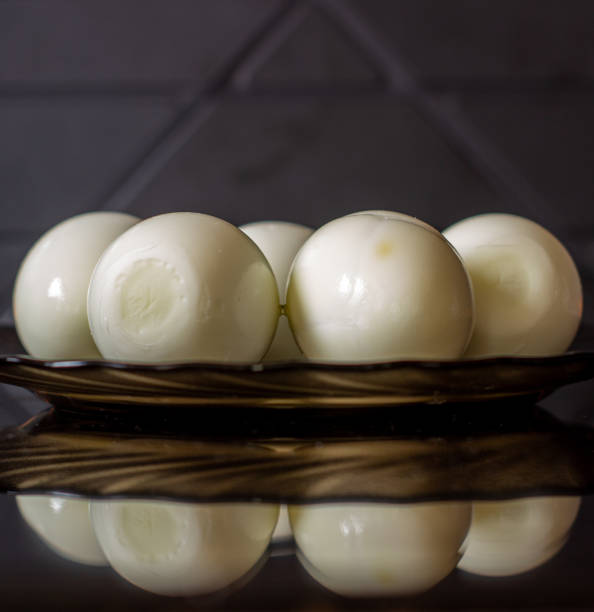 istock Peeled eggs on a black plate. Hard-boiled eggs. Cooking. 1219131496