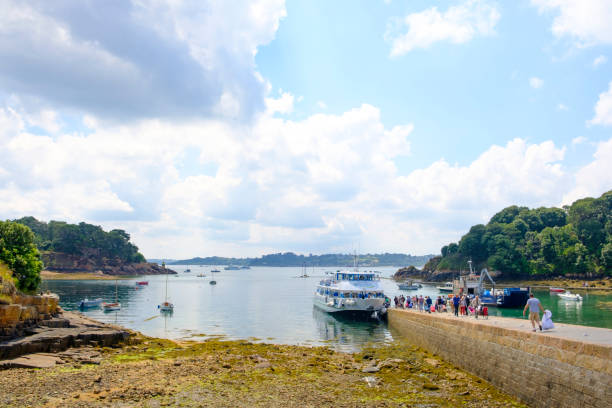 touristen, die im sommer auf der ile de bréhat an der cotes d'armor in bretagne frankreich zur fähre laufen - île de stock-fotos und bilder