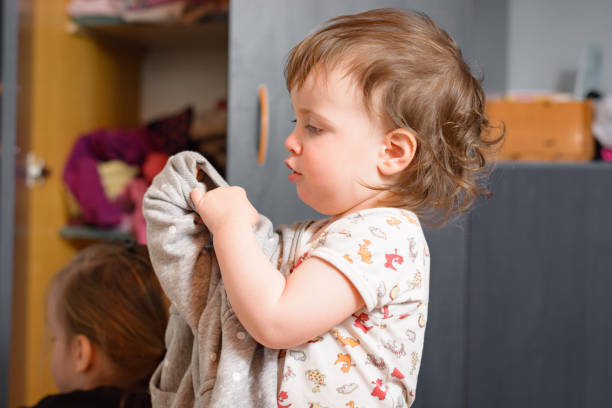 Baby girl getting dressed