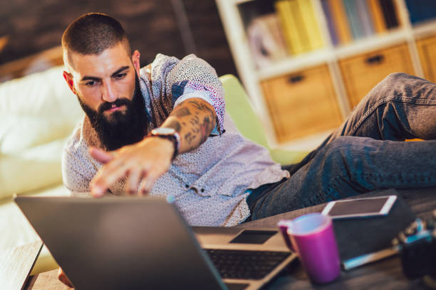 istock Young man working on his laptop computer at home 1219133563