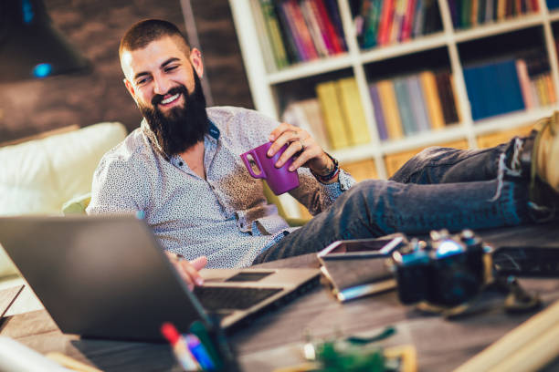 istock Young man working on his laptop computer at home 1219134369
