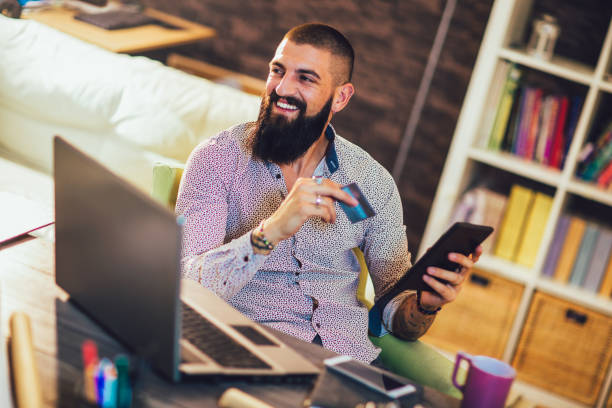 istock Man working in office using credit card for online payment 1219134675
