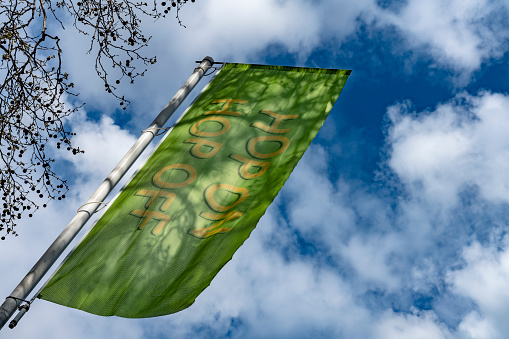 Flag advertising hop on hop off canal boats or water buses. Amsterdam, Netherlands.