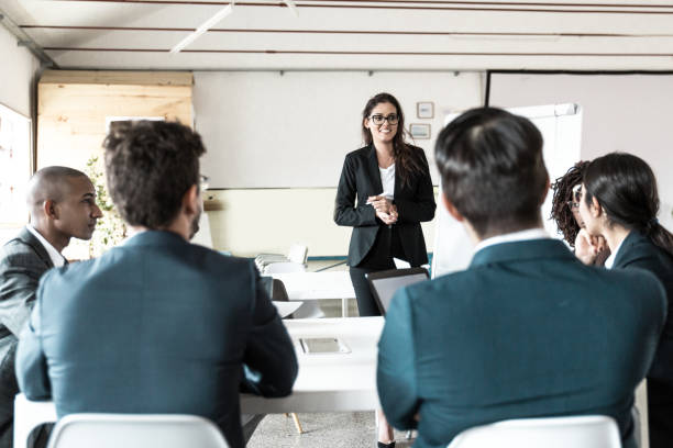 istock Smiling female business trainer working with employees 1219134689