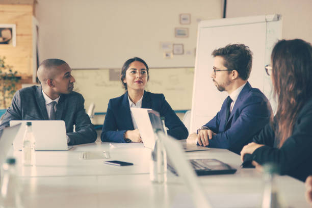 istock Group of thoughtful managers communicating during meeting 1219136143