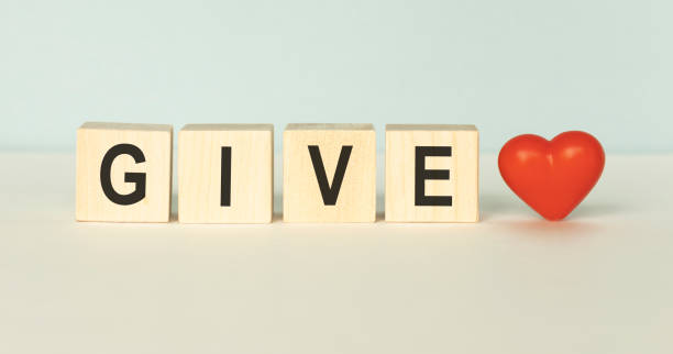istock never give up, word cube on wood background 1219137293