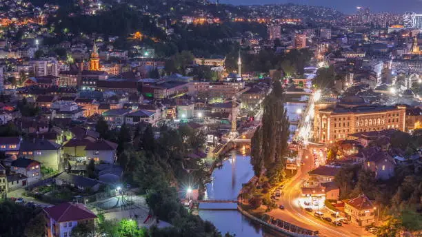 City view of Sarajevo with river from most popular panoramic spot in Sarajevo day to night transition timelapse. Road near Yellow Fortress (Zuta Tabija), Vratnik