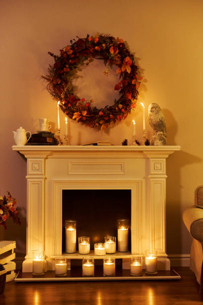 istock White fireplace with fire decorated for Autumn with candles 1219139750