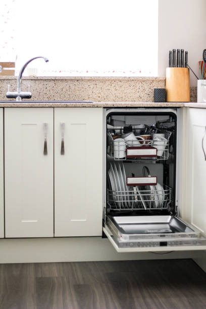 istock Stack of clean dishes in dishwasher in domestic kitchen 1219139886