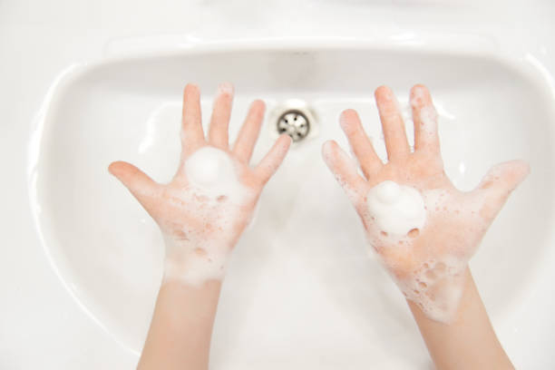 istock Splayed children's hands with soapy foam. 1219142513