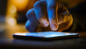 Touch Screen Smartphone Lying on the Table while Person is Typing a Message. Concept of Email Writing, Chatting in Social Media Apps, Sending an SMS, Taking Note. Close-up Macro View