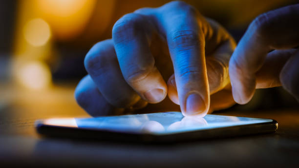 istock Touch Screen Smartphone Lying on the Table while Person is Typing a Message. Concept of Email Writing, Chatting in Social Media Apps, Sending an SMS, Taking Note. Close-up Macro View 1219143083