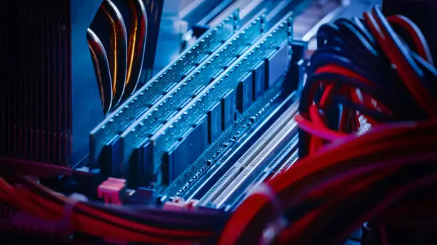 Close-up Macro Shot of Installed RAM Memory in Computer Motherboard Slot. Technically Advanced PC / Server System. Modern High-End PC Shot in Stylish Neon, Pink-Blue Colors.