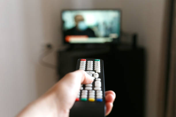 istock Hand of a man with a remote control from the TV. 1219144157