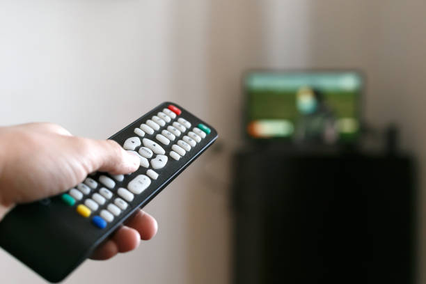 istock Hand of a man with a remote control from the TV. 1219144159