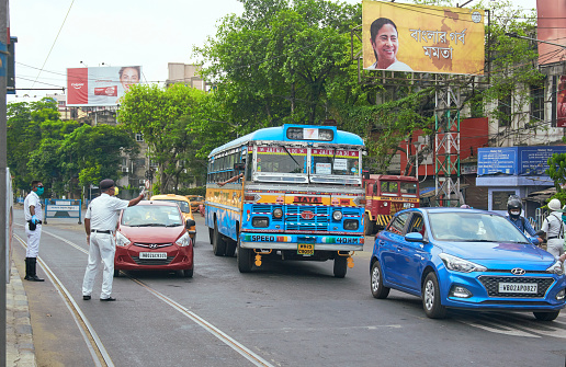 A Kolkata Police surgeon yelling at an overtaking bus driver at a traffic signal. The bus is being used by health department officials during lockdown in city.  \n\nPhoto taken at Rashbehari Avenue, Kolkata on 04/15/2020.