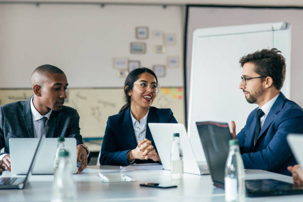 istock Group of cheerful managers communicating during meeting 1219147295