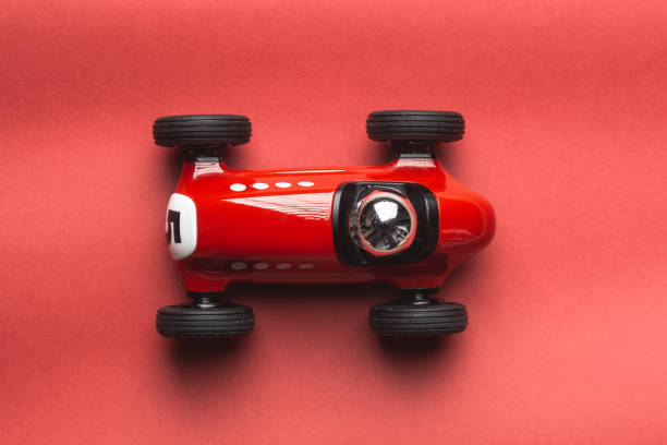 istock Red vintage toy racing car on a red background 1219147320