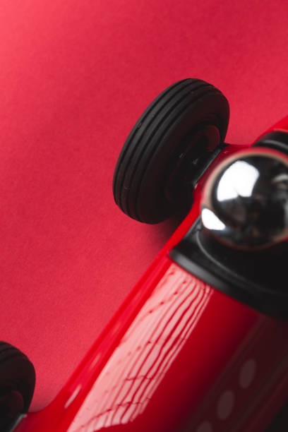 istock Red vintage toy racing car on a red background 1219147357