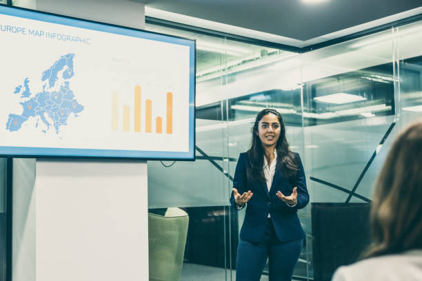 istock Confident Asian speaker talking near screen with charts 1219147776