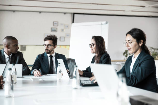 istock Group of confident managers communicating during meeting 1219149063