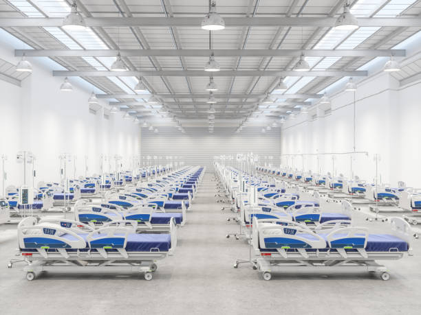 Empty Hospital Beds in a Warehouse Empty Hospital Beds in a Warehouse intensive care unit photos stock pictures, royalty-free photos & images