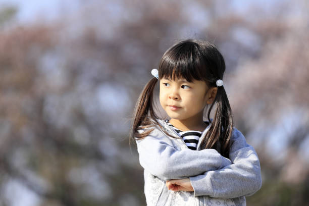 istock Japanese girl and cherry blossoms (5 years old) 1219150042