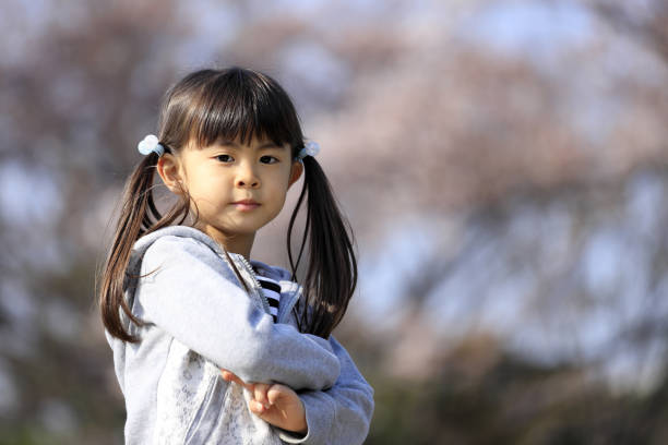 istock Japanese girl and cherry blossoms (5 years old) 1219150065