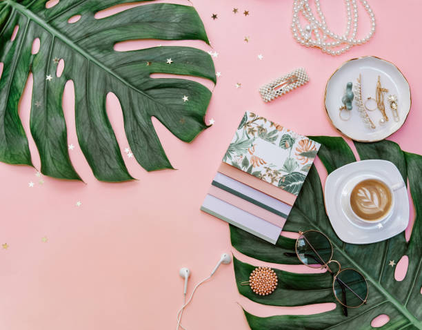 istock Modern flat lay  feminine workspace with stationery, Accessory on the pink table. Tropical View top. Still life scene 1219150207