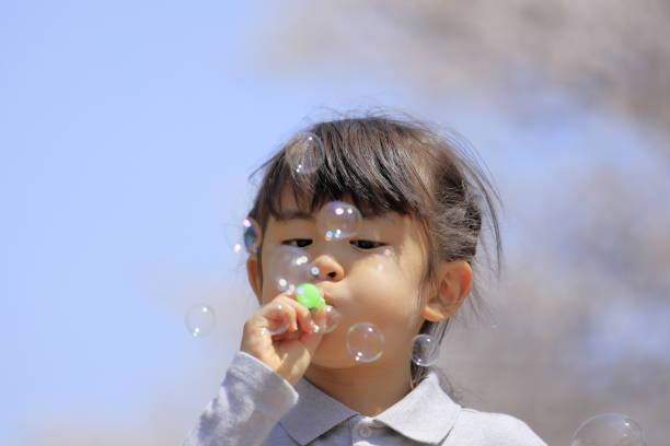 istock Japanese girl playing with bubble under the blue sky (5 years old) 1219150299