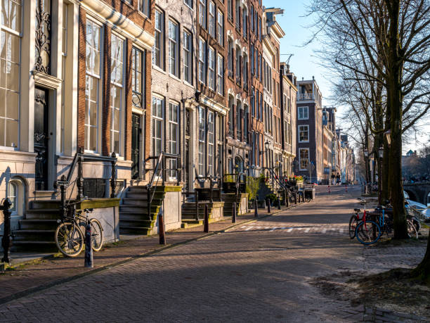 Beautiful dutch canal houses at the herengracht in Amsterdam, the Netherlands, with a blue sky