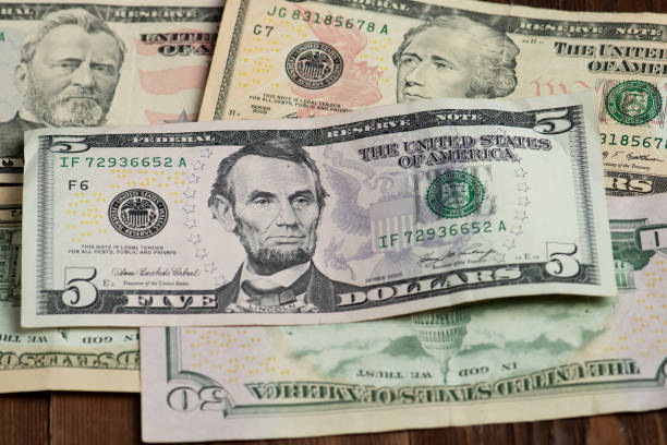istock Different banknotes of american dollars 1219153337