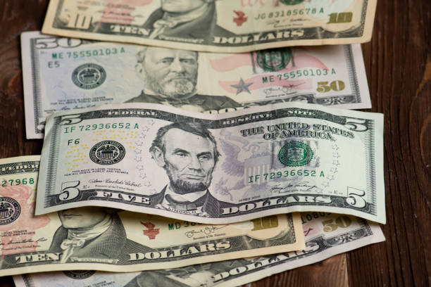 istock Different banknotes of american dollars 1219153341