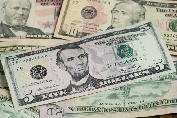 istock Different banknotes of american dollars 1219153343