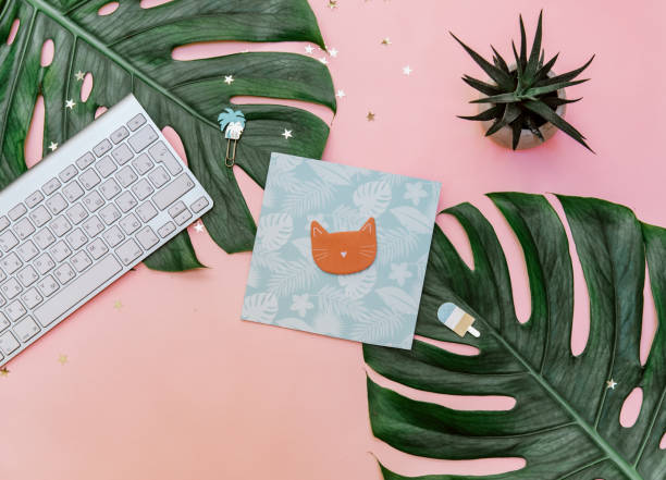 istock Top view pink tropical office desk table with notebook, computer keyboard and other office supplies. copy space, flat lay. 1219154114